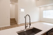 view of living space from kitchen. Stairs lead to bedroom. - 4774 Bancroft St Townhome