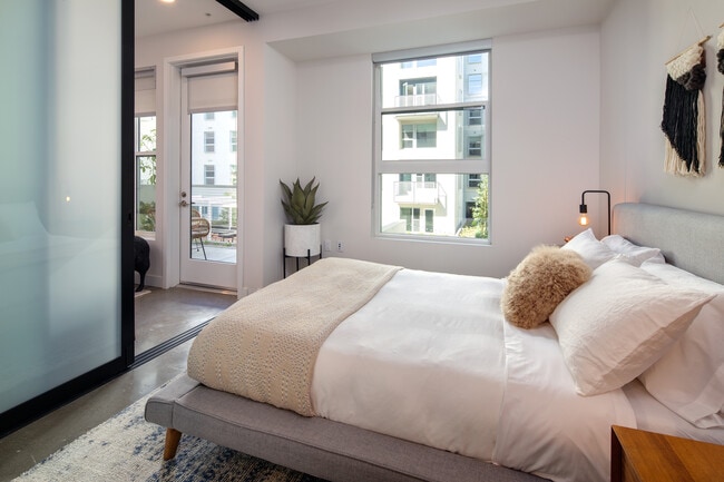 Bedroom with sliding barn door - AVA Hollywood at La Pietra Place