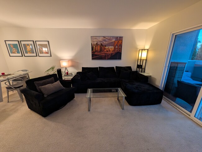 Living Room. Dining area to left and balcony to right. - 3542 Shoreline Bluff Lane