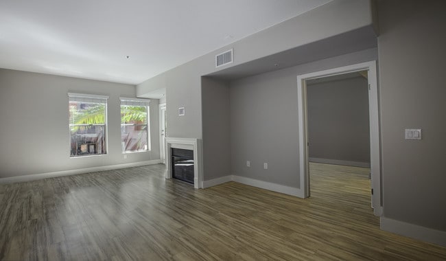 Spacious living room features a fireplace and access to private patio - Palazzo West