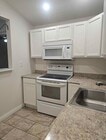 Kitchen w/refrigerator, stove, and microwave - 417 Jansu Pl Unit Cal Poly Area Studio