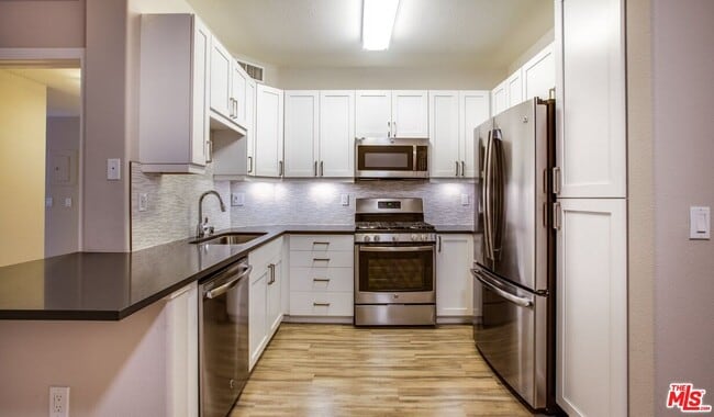 Building Photo - 6280 W 3rd St Unit 3-218