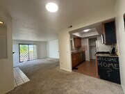 Kitching, living room, and balcony/patio - 9408 Twin Trails Dr Unit 106