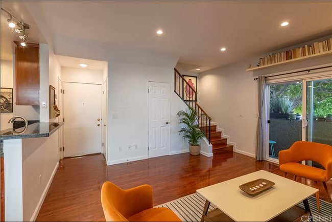 Entry way/living room. From left to right there is the kitchen, closet, front door, laundry, closet. - 1554 N Hobart Blvd Unit 2