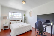 Bedroom 2 is a blend of comfort & productivity, w/ its cozy queen bed & workspace. - 2304 E 14th St House