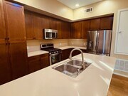 The kitchen includes an island and breakfast bar counter - 13019 Park Pl Unit 403