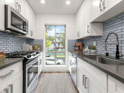 Blue tiled kitchen with stainless steel microwave, oven, and fixtures. - The Glendon Building Apartments