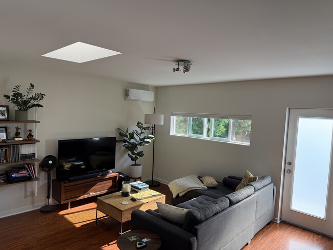 Bright living room with new mini-split A/C & heat - 4360 Stewart Ave