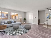 Living room with hardwood floor and view of dining area. - Riverbridge Apartments