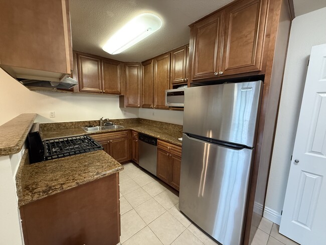 Kitchen view - tile floor and granite counters - 631 7th St Condo Unit 1