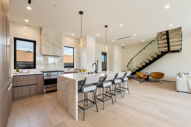 Generously sized island with stunning natural Onyx stone countertop and full-height backsplash - 836 Waterloo St