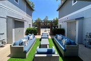Community patio with couches at the Nines Townhomes in Escondido, California. - The Nines Townhomes