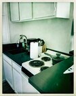Small kitchenette with 4 burner stove and oven, pots, pans, utensils and coffee maker - 15 Spinnaker St Condo Unit 3 A