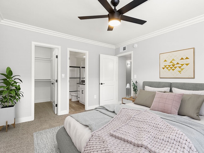 Carpeted bedroom with ceiling fan and private bathroom. - Cedar Glen
