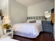 The cozy queen bed is tucked away. - 9730 Regent St House