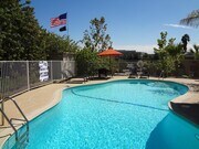Sparkling clear swimming pool and sun deck at Villa Knolls Apartments in La Mesa, California. - Villa Knolls Apartments