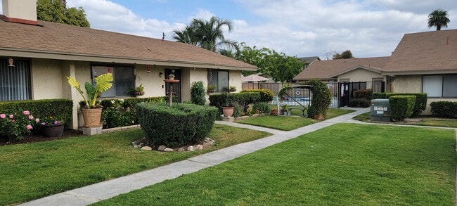 Well cared for gardens and lawn at Las Casitas Apartments in Riverside, California. - Las Casitas Apartments