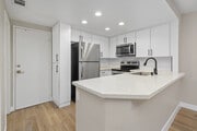 Cook, dine, and gather in a stylish kitchen space. - Promenade Terrace