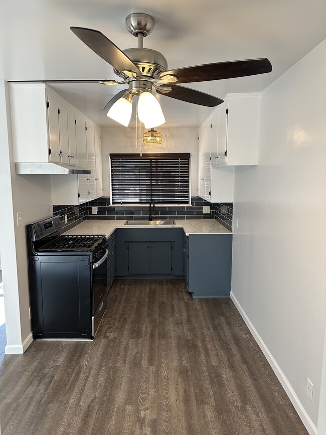 Updated kitchen with quartz countertops and stainless steel appliances - 1016 Western Ave Unit G