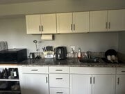 bar area with cabinetary and sink - 2300 Sunset Heights Dr Apartment Unit david younesi