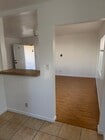 kitchen bar that opens to living room. - 4626 E 7th St Unit upstairs 1bed 1bath