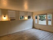 Living room looking towards front window. - 24606 University Ave Townhome