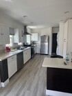 kitchen with stainless steel fridge, dishwasher, stove, oven & stacked washer & dryer; 4 seat island - 1339 S Mansfield Ave