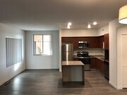Open kitchen and dining room with lots of natural light in apartment at City Plaza Apartments in Escondido, California. - City Plaza Apartments