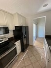 Tiled kitchen with generous cabinet and counter space - 8305 Summertime Ln Unit 8305