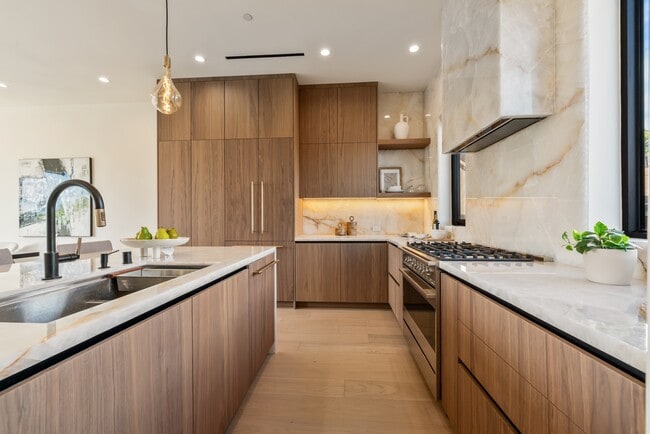 Modern kitchen featuring panel-ready Fisher & Paykel built-in appliances - 836 Waterloo St