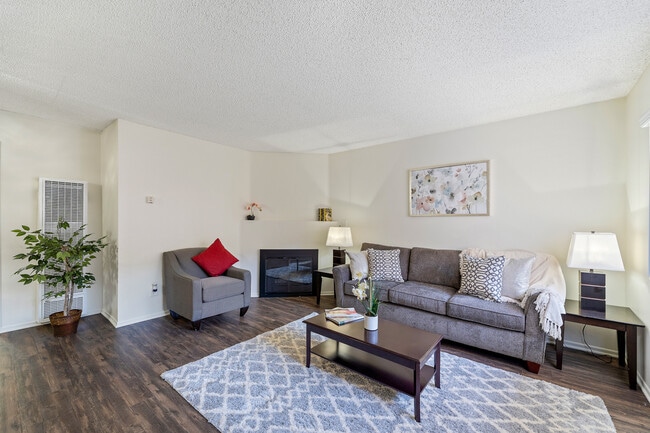 Spacious living room with a fireplace at the Enclave apartment in Studio City - The Enclave Apartments
