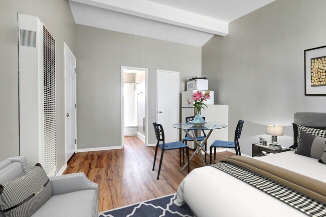 Efficiency no Full Kitchen, White refrigerator and microwave, wood-inspired floors sleeping and dining area - Fourth Avenue