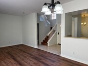 Living room to staircase view - 10924 Creekbridge Plz Townhome