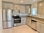Full kitchen with stainless steel appliances - The Junipero Palm Springs Apartments