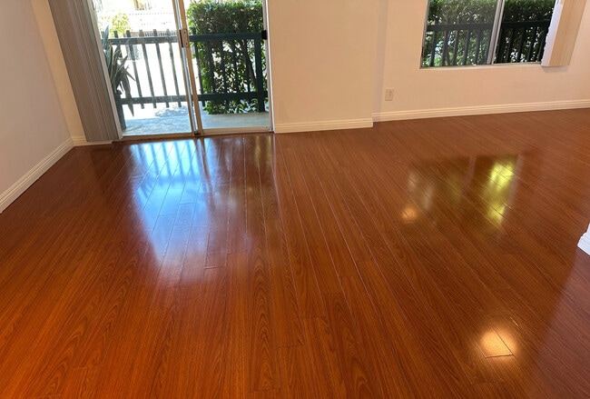 01 - Living Room + Private Patio - 1831 Barry Ave Unit 7