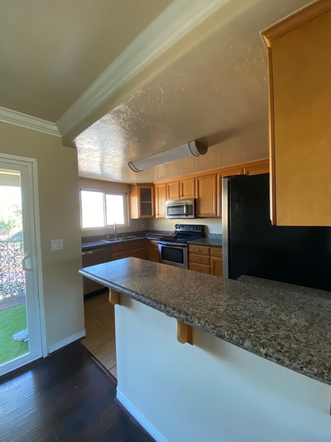Kitchen with Granite Counter Tops and Bar - 4849 Williamsburg Ln Unit 269