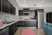 Kitchen with Refrigerator, Range Stovetop, Microwave Oven, Dishwasher, and Ample Cabinet Storage - Sherman Floor Plan - Ogden Garden by Wiseman