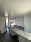 A view from the kitchen by the fridge, over the bar top. - 1911 W 94th St House