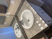 Bathroom sink with granite top and brushed nickle fixtures. - Grande Vista Apartments