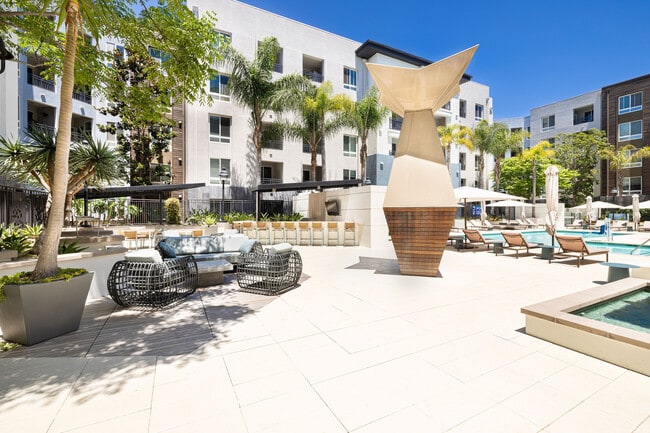 Outdoor Seating Area and Pool Deck | Elan Huntington Beach | Apartments in Huntington Beach, CA - Elan Huntington Beach