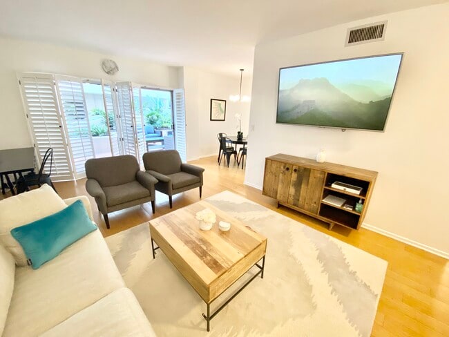Furnished Living Room with flatscreen, desk, patio doors - 1131 Alta Loma Rd Unit 123