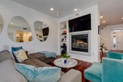 Living Room with Mounted TV and Surround Sounds Speakers - 5831 Seawalk Dr