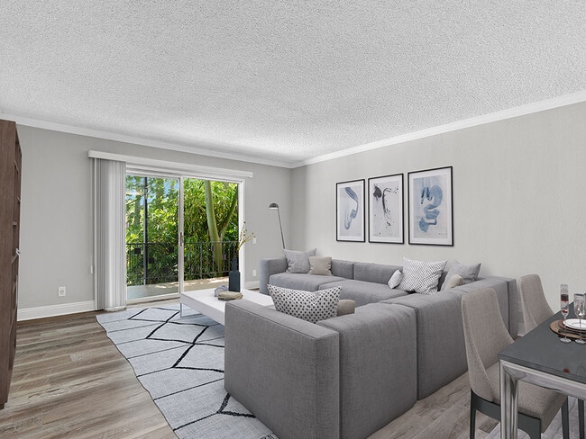Hardwood floored living room with view of outdoor patio. - Chandler Circle