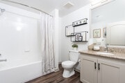 Renovated bathrooms include new lighting, faucet, and hardware - Mira Bella Apartments