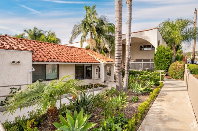 Walkway through lush landscaping - North Pointe Villas