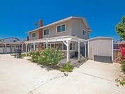 Backyard with covered patio, sheds, and hardscape - 4207 Rimcrest Dr House